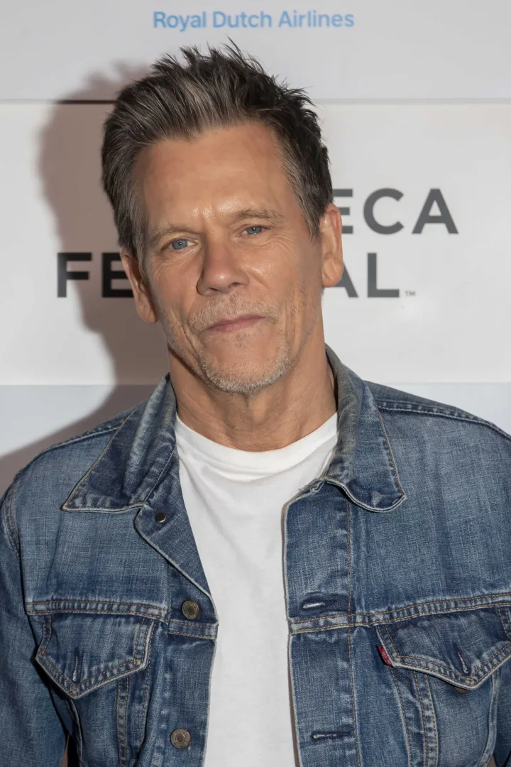 Middle-aged man with salt-and-pepper hair in denim jacket poses at Tribeca Film Festival event.