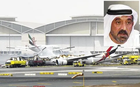 Burning Emirates aircraft on airport tarmac with fire trucks, inset portrait of a Middle Eastern man in traditional dres