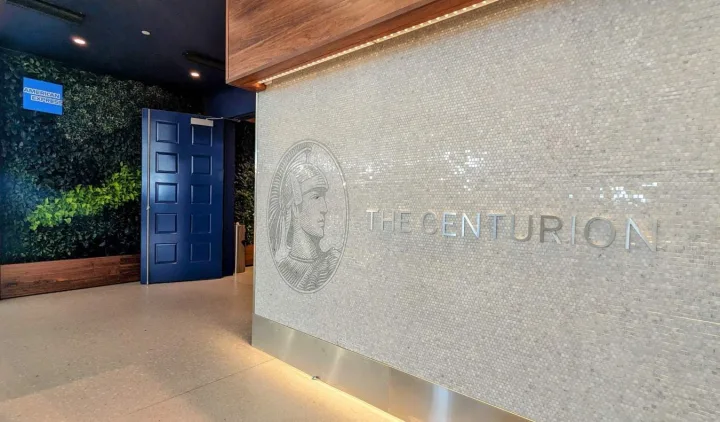 Entrance to The Centurion lounge with American Express branding on a mosaic-tiled wall.