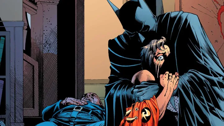 Batman cradling an injured Robin in a dark, emotional comic book scene with blood visible.